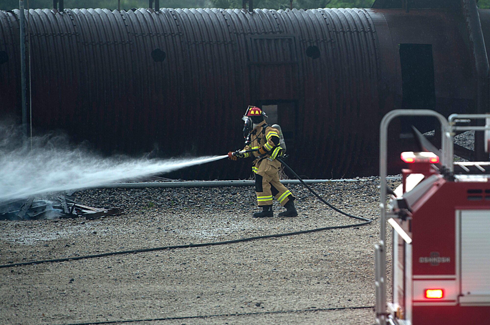 A U.S Air Force Airman assigned to the 6th Civil Engineer Squadron at MacDill Air Force Base, Fla, sprays what’s left of a spot fire during an emergency response exercise April 10, 2018.