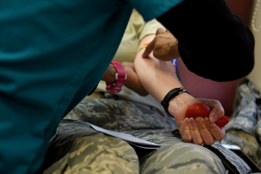 U.S. Air Force Capt. Monica Ebert, 145th Airlift Wing public affairs officer (middle) has her vein tested by Stephanie Williams (left), donor services technician with the Community Blood Center of the Carolinas (CBCC), prior to attempting a blood donation in a mobile unit at the North Carolina Air National Guard (NCANG) Base, Charlotte Douglas International Airport, April 8, 2018. The CBCC has visited the base for the last four consecutive years collecting pints of blood for patients in need across North and South Carolina. (U.S. Air Force photo by Staff Sgt. Laura J. Montgomery/)