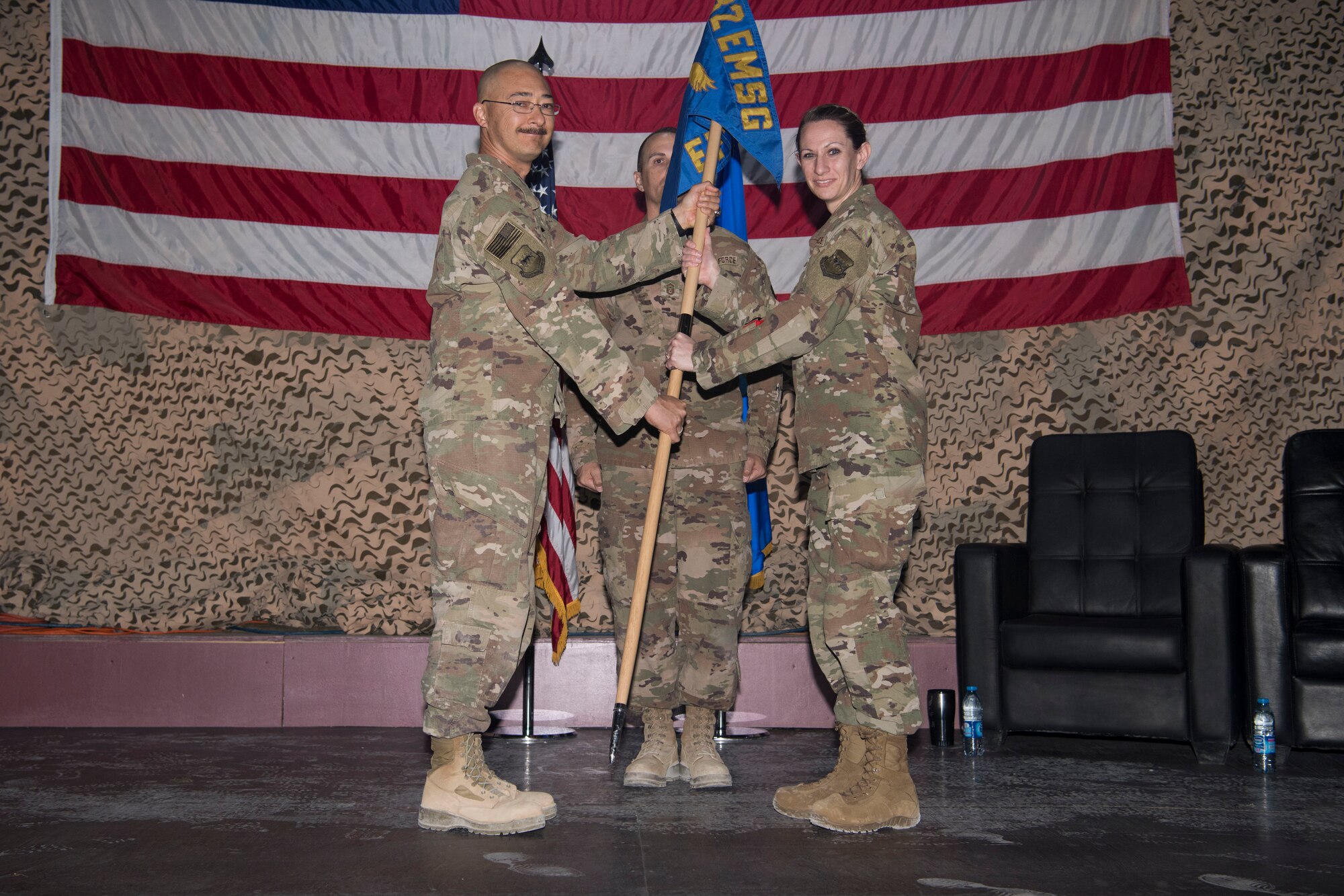 Maj. Charlene Gordon, 332nd Expeditionary Force Support Squadron incoming commander, accepts commander of the unit from Col. Christopher Fuller, 332nd Expeditionary Mission Support Group commander, during an assumption of command April 8, 2018, at an undisclosed location in Southwest Asia.