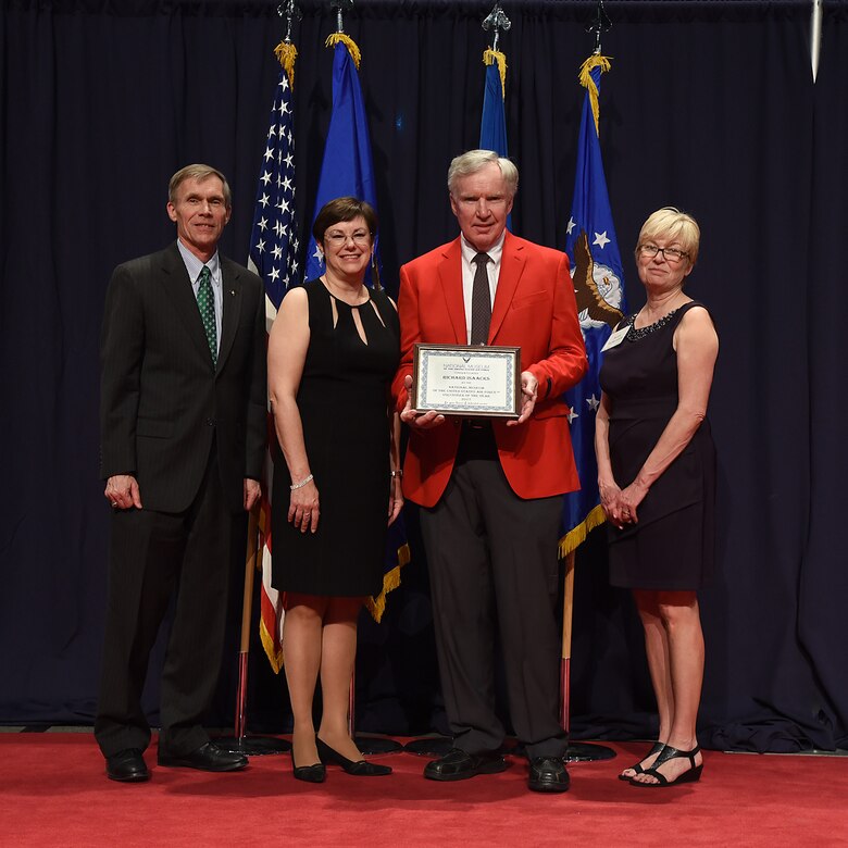 DAYTON, Ohio -- Richard Isaacks (red jacket) received the 2017 Director’s Award for Volunteer of the Year for his dedication and excellence in serving the National Museum of the U.S. Air Force. (from left to right) Museum Director Lt. Gen.(Ret.) Jack Hudson, Air Force Materiel Command Executive Director Patricia M. Young, Volunteer Richard Isaacks, and Air Force Museum Foundation Board of Trustees President Col.(Ret.) Susan E. Richardson . (U.S. Air Force photo)