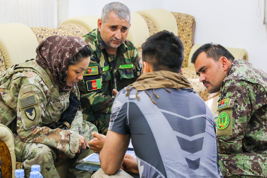 Army Master Sgt. Janet Bretado, logistics advisor for Train, Advise and Assist Command South’s military advisory team, meets with her Afghan counterparts in Kandahar, Afghanistan.