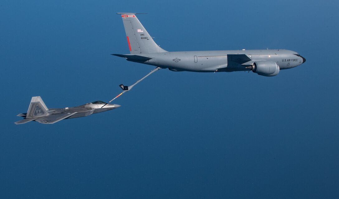 A KC-135 Stratotanker from the 121st Air Refueling Wing refuels an F-22 Raptor from the 1st Fighter Wing over the Atlantic Ocean, April 12, 2018. The 1st Fighter Wing is home to the 94th Fighter Squadron and 27th Fighter Squadron at Joint Base Langley-Eustis, Va. and the 121st ARW is from Rickenbacker Air National Guard Base, Ohio. (U.S. Air Force photo by Staff Sgt. Carlin Leslie)
