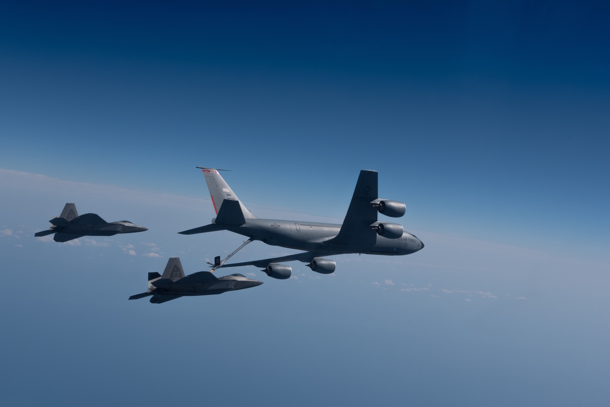 A KC-135 Stratotanker from the 121st Air Refueling Wing refuels F-22 Raptors from the 94th Fighter Squadron and 27th Fighter Squadron over the Atlantic Ocean, April 12, 2018. The 94th FS and 27th FS are the fighter squadrons of the 1st Fighter Wing at Joint Base Langley-Eustis, Va. and the 121st ARW is from Rickenbacker Air National Guard Base, Ohio. (U.S. Air Force photo by Staff Sgt. Carlin Leslie)