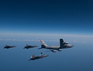 A KC-135 Stratotanker from the 121st Air Refueling Wing refuels F-22 Raptors from the 94th Fighter Squadron and 27th Fighter Squadron over the Atlantic Ocean, April 12, 2018. The 94th FS and 27th FS are the fighter squadrons of the 1st Fighter Wing at Joint Base Langley-Eustis, Va. and the 121st ARW is from Rickenbacker Air National Guard Base, Ohio. (U.S. Air Force photo by Staff Sgt. Carlin Leslie)