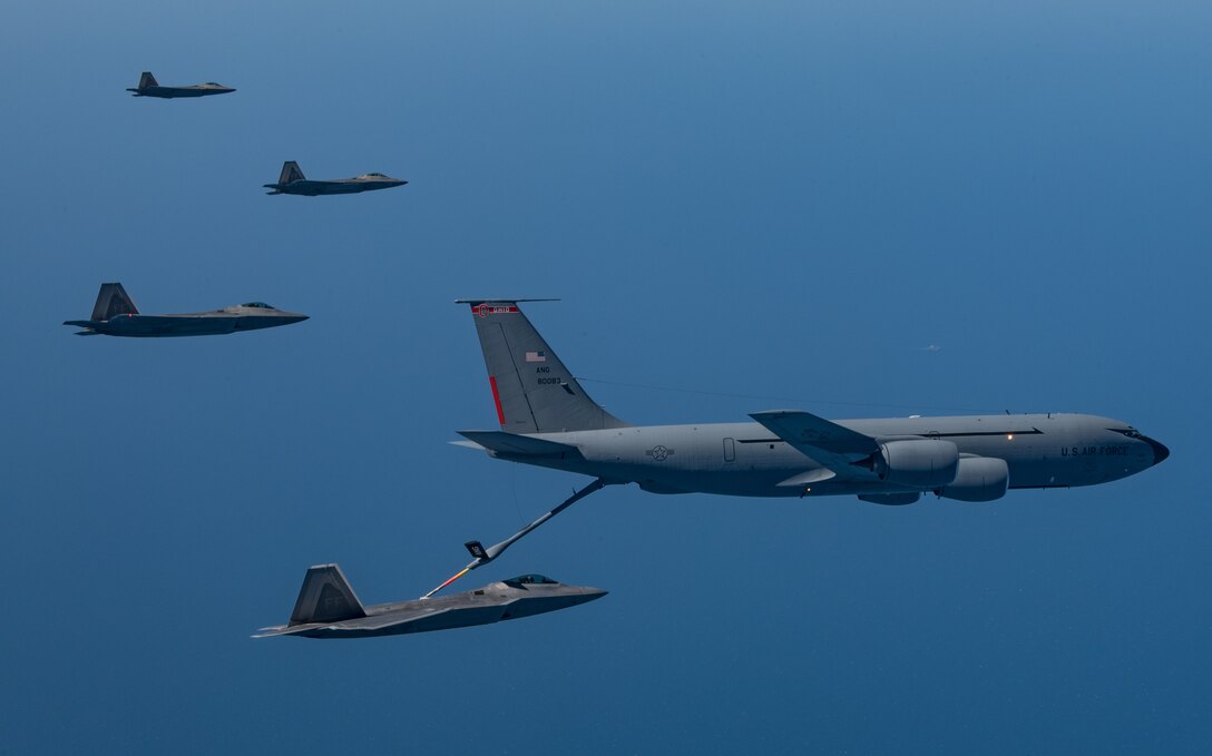 A KC-135 Stratotanker from the 121st Air Refueling Wing refuels F-22 Raptors from the 94th Fighter Squadron and 27th Fighter Squadron over the Atlantic Ocean, April 12, 2018. The 94th FS and 27th FS are the fighter squadrons of the 1st Fighter Wing at Joint Base Langley-Eustis, Va. and the 121st ARW is from Rickenbacker Air National Guard Base, Ohio. (U.S. Air Force photo by Staff Sgt. Carlin Leslie)