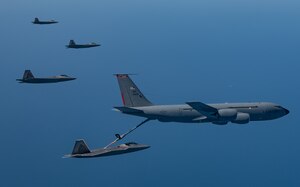 A KC-135 Stratotanker from the 121st Air Refueling Wing refuels F-22 Raptors from the 94th Fighter Squadron and 27th Fighter Squadron over the Atlantic Ocean, April 12, 2018. The 94th FS and 27th FS are the fighter squadrons of the 1st Fighter Wing at Joint Base Langley-Eustis, Va. and the 121st ARW is from Rickenbacker Air National Guard Base, Ohio. (U.S. Air Force photo by Staff Sgt. Carlin Leslie)