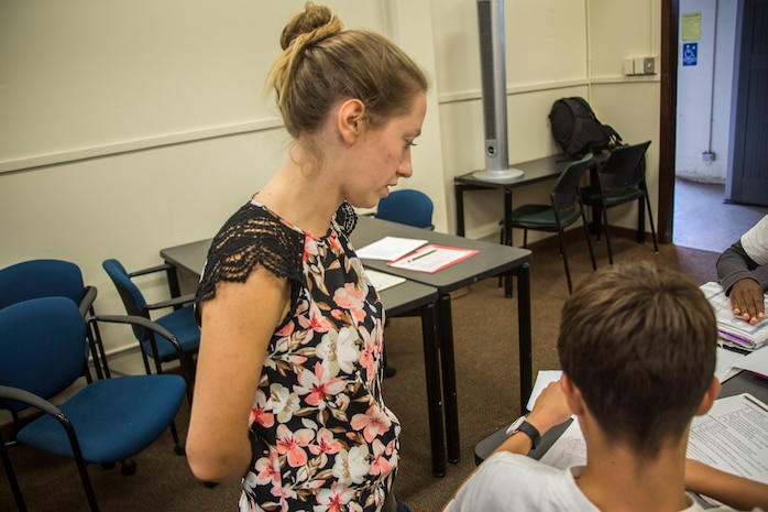 Lauren Brown, an advanced algebra one teacher from Kailua Intermediate School (KIS), watches a student from KIS work on his homework during a “Counting on Math” tutoring session at the Education Center, Marine Corps Base Hawaii, April 12, 2018. The Count on Math tutoring program focuses on helping students with their mathematics skills while also exploring other subjects. (U.S. Marine Corps photo by Lance Cpl. Matthew Kirk)