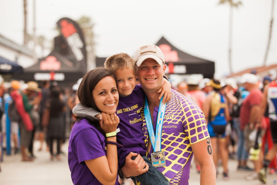 U.S. Marine Corps Capt. John Watkins, the battery commander of Bravo Battery, 1st Battalion, 11th Marine Regiment, 1st Marine Division, and his family celebrate his finish at the 2018 Ironman 70.3 Oceanside Triathlon in Oceanside, Calif., April 7, 2018. Watkins competed in the event to honor the memory of his daughter, Amelia or "Millie," who passed away from neuroblastoma in June 2017. “Before she died, my wife and I promised her we would do big things in her name,” said Watkins. “She will never be forgotten.” (Courtesy photo)