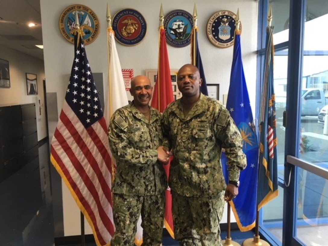 From left to right Navy Capt Roy Love, commanding officer, Naval Base San Diego and Navy Capt J. R. White, commander, DLA Distribution San Diego, California.