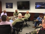 Naval Base San Diego commanding officer Navy Capt. Roy Love (center) discusses his leadership philosophy and his 2035 Plan with the DLA Distribution San Diego team.