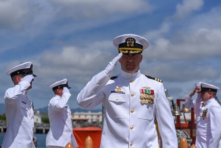Cmdr. Christopher Hedrick, commanding officer of the Los Angeles-class fast-attack submarine USS Santa Fe (SSN 763) is piped ashore following a change of command ceremony on the submarine piers in Joint Base Pearl Harbor-Hickam, April 13.