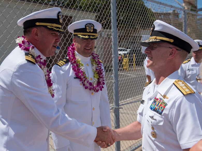 Rear Adm. Daryl L. Caudle, commander, Submarine Force, U.S. Pacific Fleet, right, congratulates Cmdr. Jacob A. Foret following the Los Angeles-class fast-attack submarine USS Santa Fe (SSN 763) change of command ceremony on the submarine piers in Joint Base Pearl Harbor-Hickam, April 13.