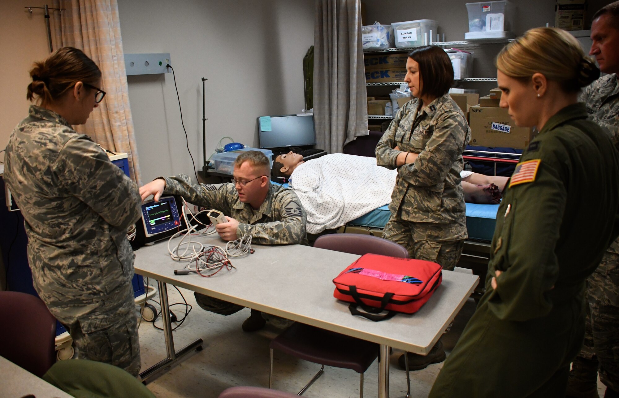 At center, Master Sgt. Thomas Dissette, 932nd Airlift Wing, 932nd Medical Group, 932nd Aeromedical Staging Squadron, teaches a class on taking care of critically ill patients recently at Scott Air Force Base, Ill.  He works through the steps required to use a piece of equipment called the "Propaq", which helps monitor his simulated robotic patient, also known as "simulation man" (in background).  The Propaq MD offers multiple display modes to operate in bright sunlight or during night missions (NVG-friendly display). The battery system and AC power charger provide worldwide sea, land, and air operating capabilities for the rugged device.  (U.S. Air Force photo by Lt. Col. Stan Paregien)