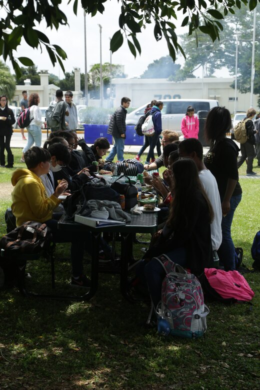 CAMP FOSTER, OKINAWA, Japan – Students sit outside eating during the Kubasaki High School Month of the Military Child barbecue April 10 aboard Camp Foster, Okinawa, Japan.