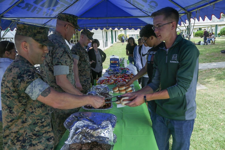CAMP FOSTER, OKINAWA, Japan – Senior Marine Corps leadership serve students lunch during the Kubasaki High School Month of the Military Child barbecue April 10 aboard Camp Foster, Okinawa, Japan.