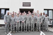 The 86th Vehicle Readiness Squadron vehicle operations flight poses for a group photo on Ramstein Air Base, Germany, April 11, 2018. Between 2016 and 2017, the 86th VRS Vehicle Operations Flight decreased accidents by 40 percent, and saved approximately $21,800 in total savings and cost avoidance the last year. Innovation Madness is a competition-based outreach campaign promoting continuous process improvement and cultivating a culture of innovation throughout U.S. Air Forces in Europe. (U.S. Air Force photo by Senior Airman Savannah L. Waters)