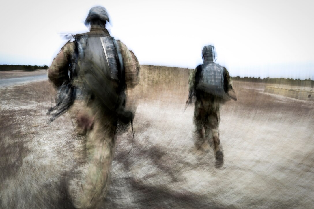 Soldiers rush toward an objective.