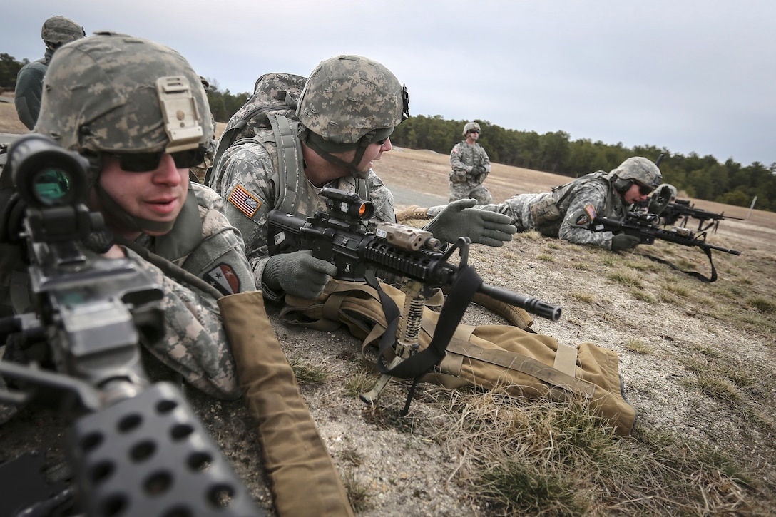 Soldiers prepare to fire automatic weapons at target.
