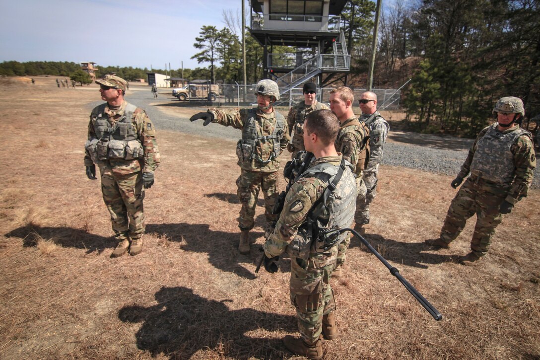 Commander mentors his soldiers during training.