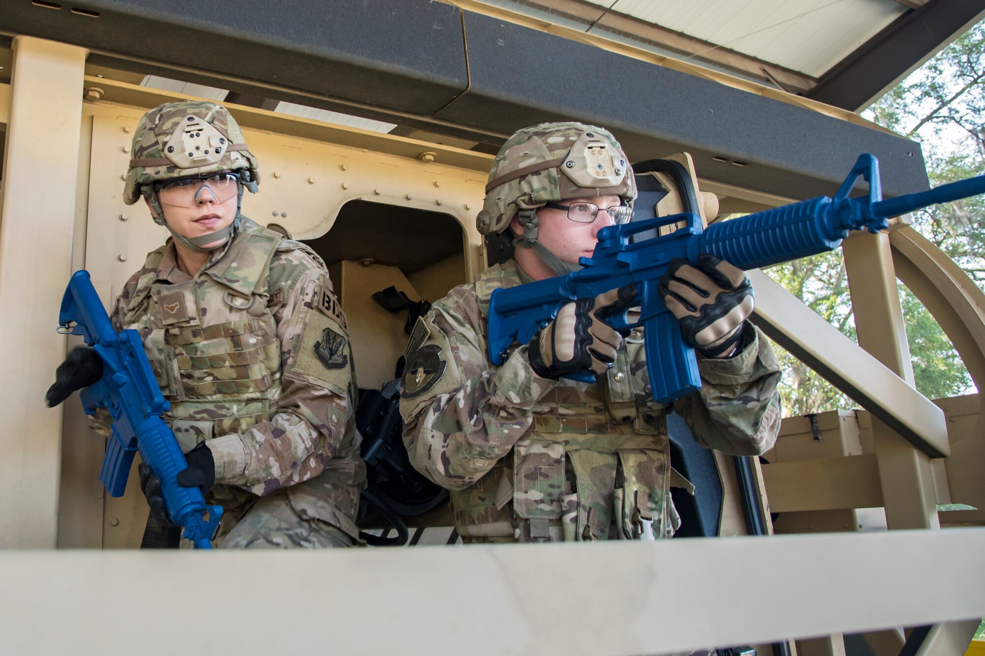 Airmen from the 824th Base Defense Squadron establish a perimeter surrounding a mine-resistant, ambush-protected (MRAP) vehicle roll-over simulator during an Emerge Moody tour, April 12, 2018, at Moody Air Force Base, Ga. Emerge Moody is a program in which select Airmen and civilians tour various units to gain a better understanding of the installations overall mission, capabilities and comprehensive duties. During their tour of the 820th Base Defense Group, Emerge Moody members observed and participated in various demonstrations such as a MRAP rollover simulator, full-mission brief, a sniper display and a tactical gear and static vehicle presentation. (U.S. Air Force photo by Airman 1st Class Eugene Oliver)
