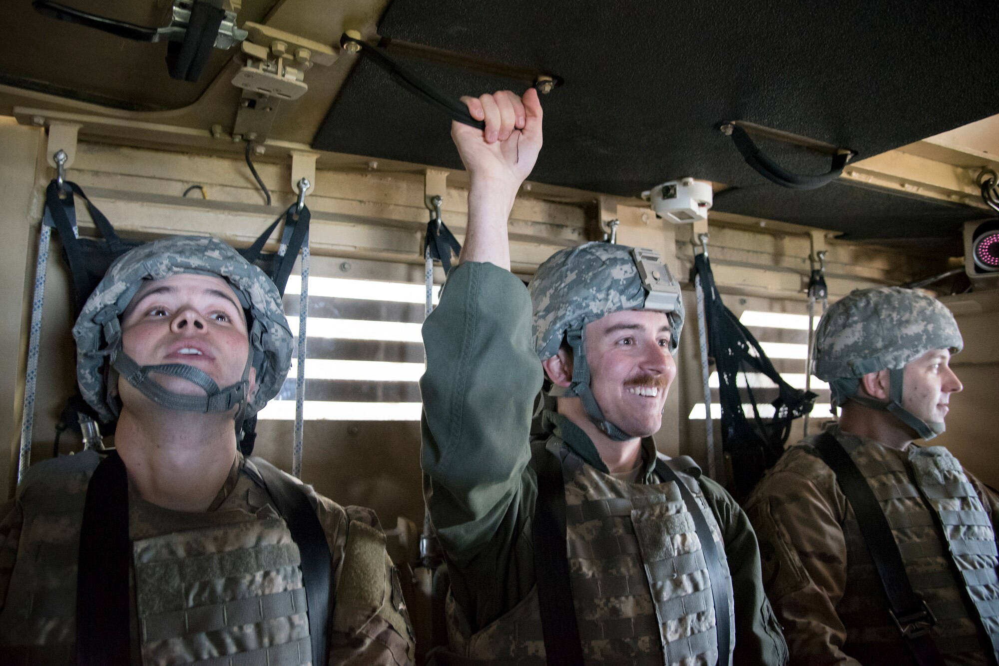 Airmen from the Emerge Moody program prepare to participate in a mine-resistant, ambush-protected (MRAP) vehicle roll-over simulation, April 12, 2018, at Moody Air Force Base, Ga. Emerge Moody is a program in which select Airmen and civilians tour various units to gain a better understanding of the installations overall mission, capabilities and comprehensive duties. During their tour of the 820th Base Defense Group, Emerge Moody members observed and participated in various demonstrations such as a MRAP rollover simulator, full-mission brief, a sniper display and a tactical gear and static vehicle presentation. (U.S. Air Force photo by Airman 1st Class Eugene Oliver)