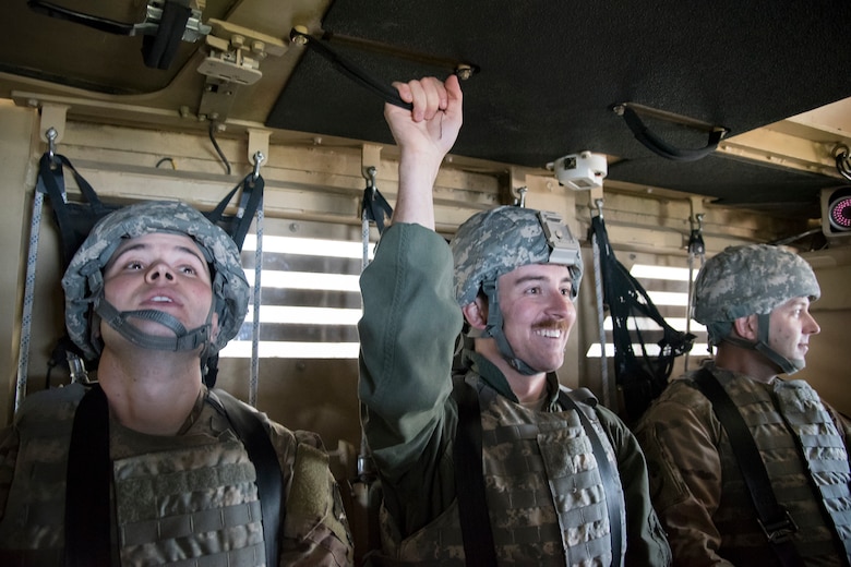 Airmen from the Emerge Moody program prepare to participate in a mine-resistant, ambush-protected (MRAP) vehicle roll-over simulation, April 12, 2018, at Moody Air Force Base, Ga. Emerge Moody is a program in which select Airmen and civilians tour various units to gain a better understanding of the installations overall mission, capabilities and comprehensive duties. During their tour of the 820th Base Defense Group, Emerge Moody members observed and participated in various demonstrations such as a MRAP rollover simulator, full-mission brief, a sniper display and a tactical gear and static vehicle presentation. (U.S. Air Force photo by Airman 1st Class Eugene Oliver)