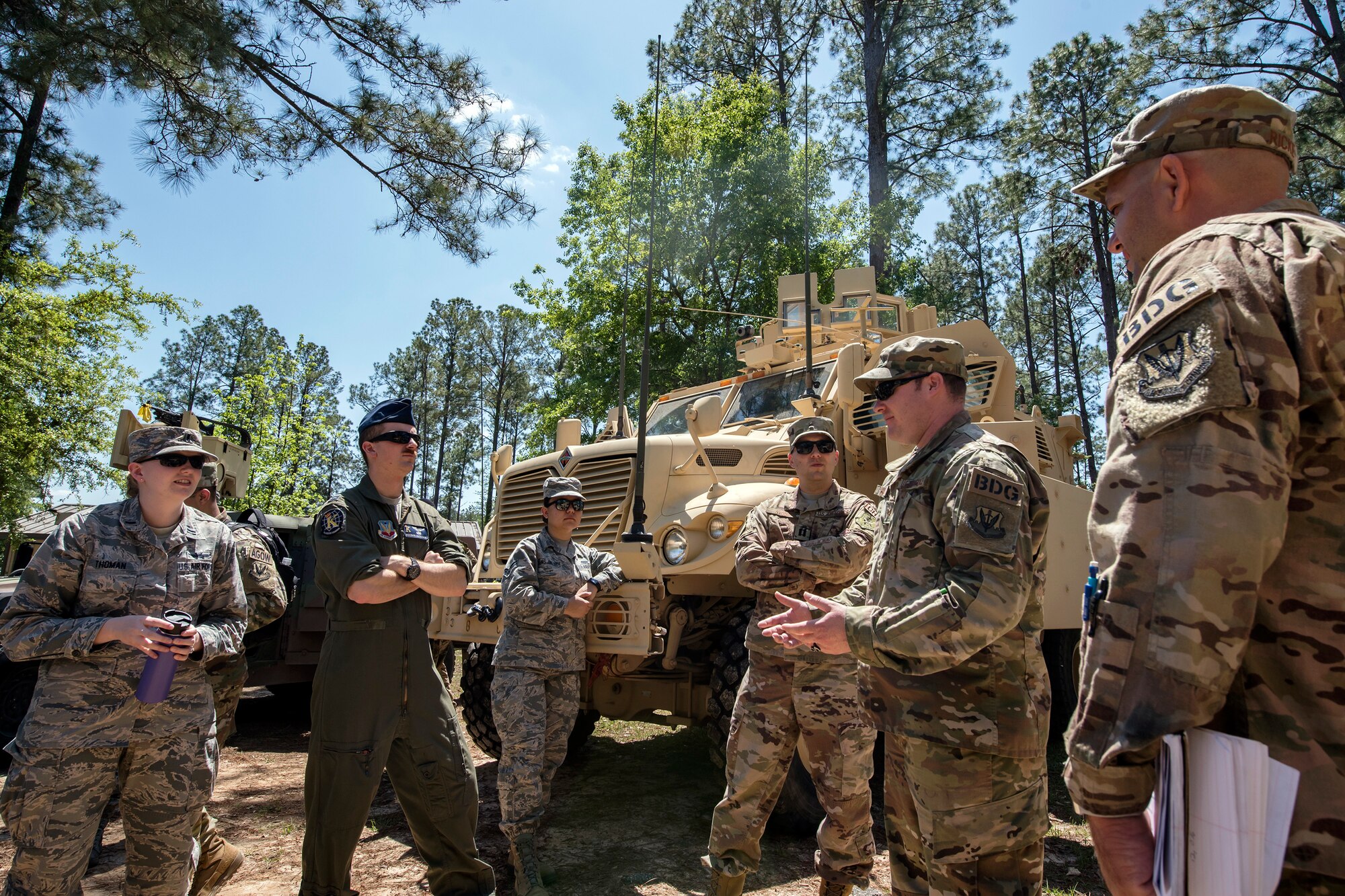 Airmen from the 820th Base Defense Group (BDG) give a static vehicle briefing to Emerge Moody members, April 12, 2018, at Moody Air Force Base, Ga. Emerge Moody is a program in which select Airmen and civilians tour various units to gain a better understanding of the installations overall mission, capabilities and comprehensive duties. During their tour of the 820th Base Defense Group, Emerge Moody members observed and participated in various demonstrations such as a mine-resistant, ambush-protected vehicle rollover simulator, full-mission brief, a sniper display and a tactical gear and static vehicle presentation. (U.S. Air Force photo by Airman 1st Class Eugene Oliver)