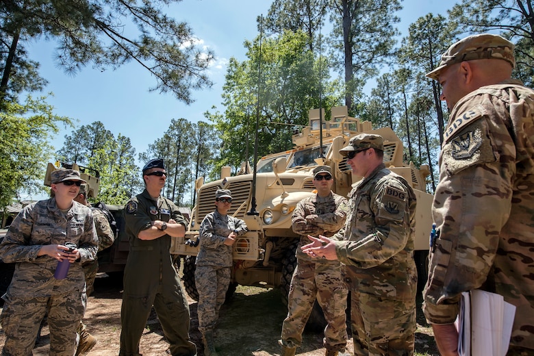 Airmen from the 820th Base Defense Group (BDG) give a static vehicle briefing to Emerge Moody members, April 12, 2018, at Moody Air Force Base, Ga. Emerge Moody is a program in which select Airmen and civilians tour various units to gain a better understanding of the installations overall mission, capabilities and comprehensive duties. During their tour of the 820th Base Defense Group, Emerge Moody members observed and participated in various demonstrations such as a mine-resistant, ambush-protected vehicle rollover simulator, full-mission brief, a sniper display and a tactical gear and static vehicle presentation. (U.S. Air Force photo by Airman 1st Class Eugene Oliver)