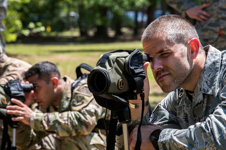 Airmen from Emerge Moody look through a magnified sight, April 12, 2018, at Moody Air Force Base, Ga. Emerge Moody is a program in which select Airmen and civilians tour various units to gain a better understanding of the installations overall mission, capabilities and comprehensive duties. During their tour of the 820th Base Defense Group, Emerge Moody members observed and participated in various demonstrations such as a mine-resistant, ambush-protected vehicle rollover simulator, full-mission brief, a sniper display and a tactical gear and static vehicle presentation. (U.S. Air Force photo by Airman 1st Class Eugene Oliver)