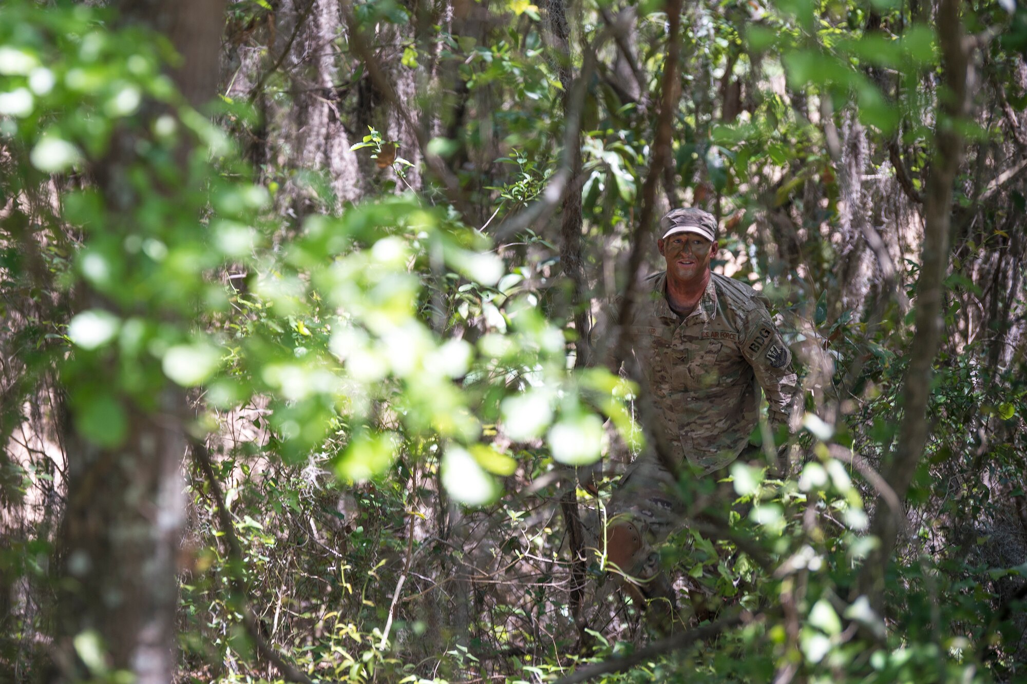 Airman 1st Class Jared Walker, 824th Base Defense Squadron fireteam member, makes himself seen as part of a sniper demonstration during an Emerge Moody tour, April 12, 2018, at Moody Air Force Base, Ga. Emerge Moody is a program in which select Airmen and civilians tour various units to gain a better understanding of the installations overall mission, capabilities and comprehensive duties. During their tour of the 820th Base Defense Group, Emerge Moody members observed and participated in various demonstrations such as a mine-resistant, ambush-protected vehicle rollover simulator, full-mission brief, a sniper display and a tactical gear and static vehicle presentation. (U.S. Air Force photo by Airman 1st Class Eugene Oliver)