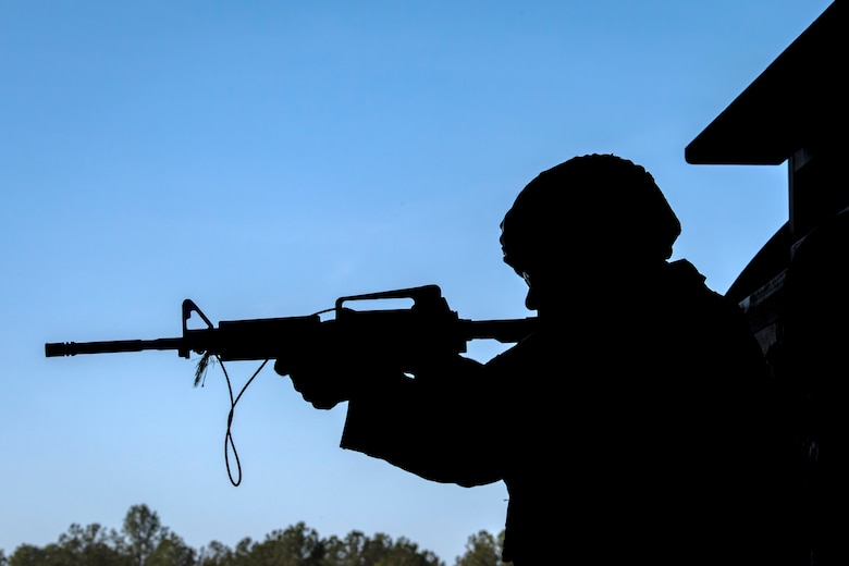 Airman Ricky Ross, 824th Base Defense Squadron fireteam member, looks down the sight of a simulated weapon during an Emerge Moody tour, April 12, 2018, at Moody Air Force Base, Ga. Emerge Moody is a program in which select Airmen and civilians tour various units to gain a better understanding of the installations overall mission, capabilities and comprehensive duties. During their tour of the 820th Base Defense Group, Emerge Moody members observed and participated in various demonstrations such as a mine-resistant, ambush-protected vehicle rollover simulator, full-mission brief, a sniper display and a tactical gear and static vehicle presentation. (U.S. Air Force photo by Airman 1st Class Eugene Oliver)