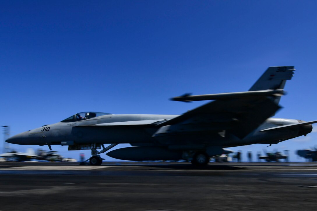 A plane takes off from the flight deck of the USS Theodore Roosevelt.