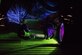 An Airman looks at an aircraft part beside a black light.