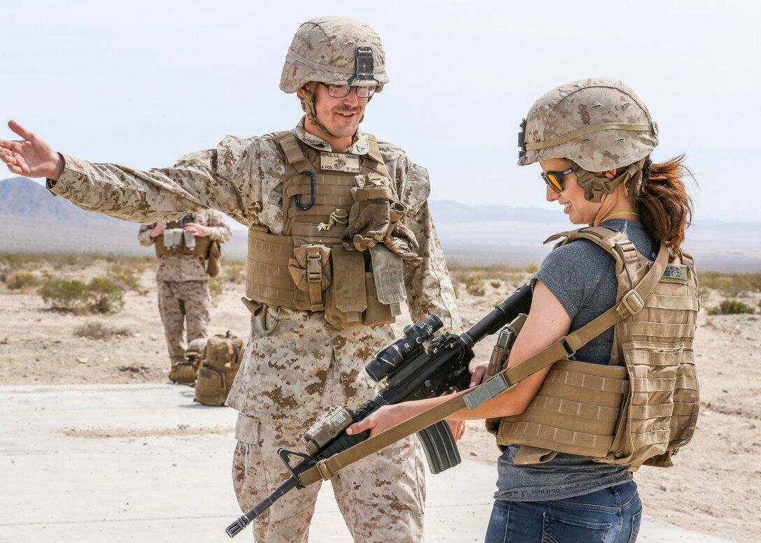 Sara Nepple, wife of Cpl. Caleb Nepple, gunner, Alpha Company, 1st Tank Battalion, receives instruction on how to fire the M16A4 service rifle from her husband during the unit’s Jane Wayne Spouse Appreciation Day aboard the Marine Corps Air Ground Combat Center, Twentynine Palms, Calif., April 3, 2018. The purpose of the event is to build resiliency in spiritual well being, the will to fight and a strong home life for the 1st Tanks Marines and their families. (U.S. Marine Corps photo by Lance Cpl. Rachel K. Porter)