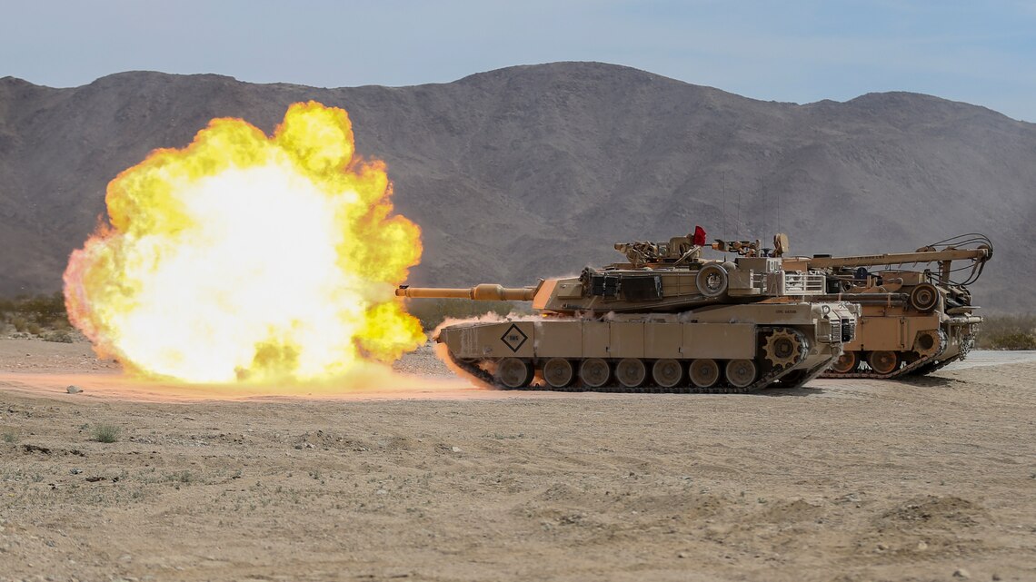 An M1A1 Abrams Tank fires off a round as a demonstration during 1st Tank Battalion’s Jane Wayne Spouse Appreciation Day aboard the Marine Corps Air Ground Combat Center, Twentynine Palms, Calif., April 3, 2018. The purpose of the event is to build resiliency in spiritual well being, the will to fight and a strong home life for the 1st Tanks Marines and their families. (U.S. Marine Corps photo by Lance Cpl. Rachel K. Porter)