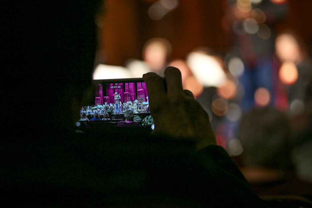 A member of the audience records U.S. Marine Corps Cpl. Denzell Ivory, a musician percussionist for 1st Marine Division Band, during the 1st Marine Division Band’s 10th annual concert at the California Center for the Arts, Escondido, Calif., March 29, 2018.The performance displayed the Marine Corps' commitment to musical excellence while performing traditional military pieces to the local community. (U.S. Marine Corps photo by LCpl. Rhita Daniel)