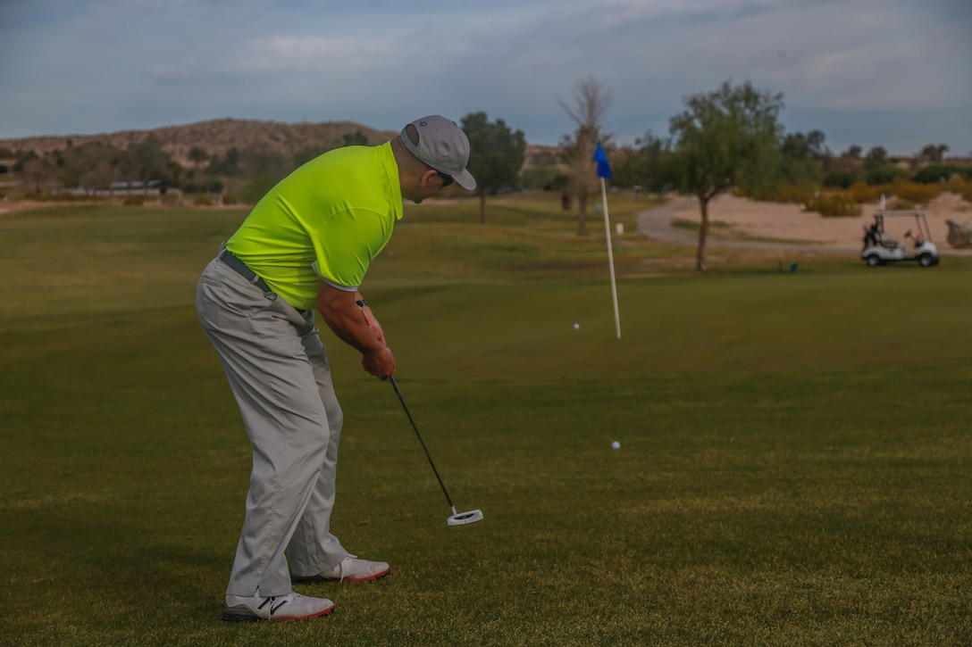 A competitor putts onto the green at the first-ever True Grit Tournament at the Desert Winds Golf Course aboard the Marine Corps Air Ground Combat Center, Twentynine Palms, Calif., April 6, 2018. The tournament was held to raise money for Marine Corps Logistics Operations Group’s Marine Corps Birthday Ball while also building relations between the host unit and other units on base. (U.S. Marine Corps photo by Lance Cpl. Preston L. Morris)