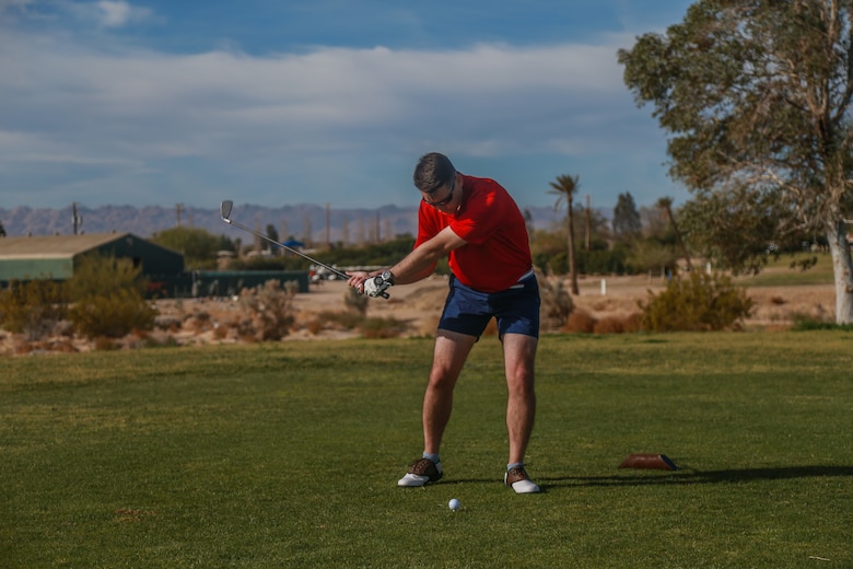Maj. Kieran O’Neil, instructor, Marine Corps Logistics Operations Group, tees off at the first-ever True Grit Tournament at the Desert Winds Golf Course aboard the Marine Corps Air Ground Combat Center, Twentynine Palms, Calif., April 6, 2018. The tournament was held to raise money for MCLOG’s Marine Corps Birthday Ball while building relations between the host unit and other units on base. (U.S. Marine Corps photo by Lance Cpl. Preston L. Morris)