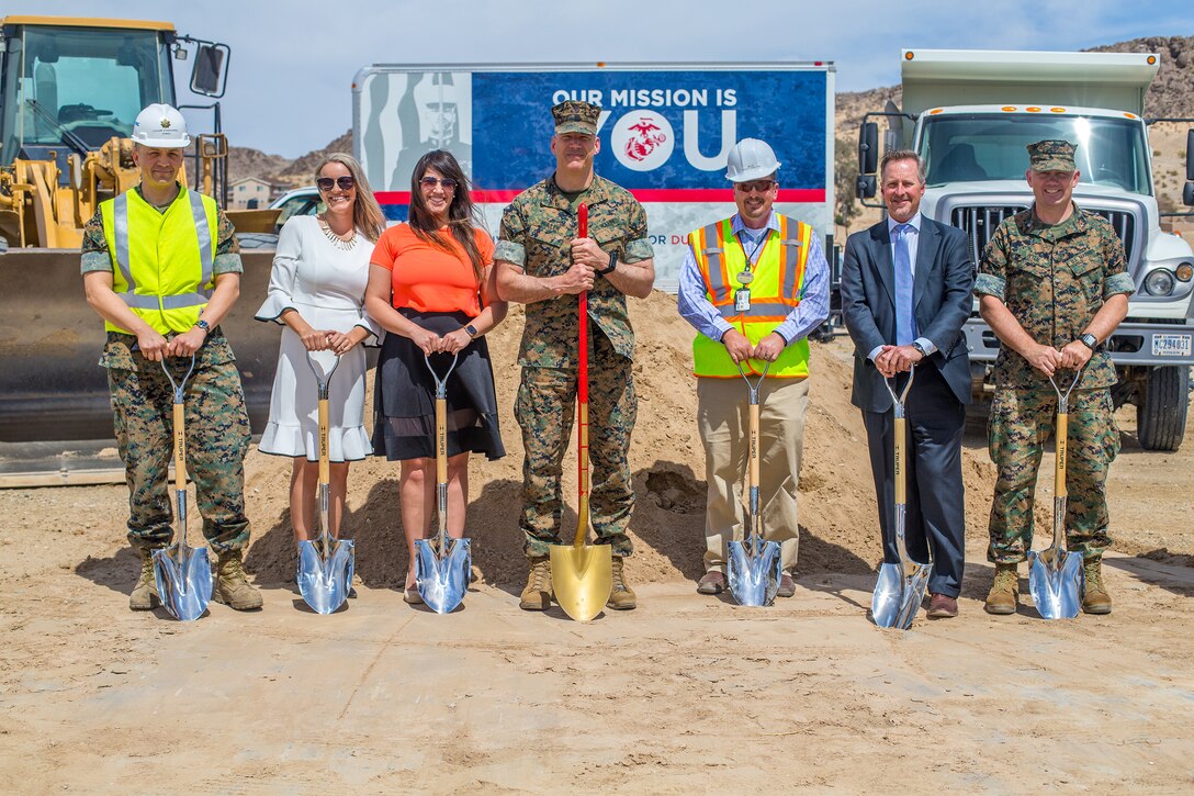 The team that helped make the new building of the Inns of the Corps possible stands in front of the construction site during the ground breaking ceremony aboard the Marine Corps Air Ground Combat Center, Twentynine Palms, Calif., April 5, 2018. The newest addition to the installation will have twice the rooms and up-to-date amenities for Marines changing duty stations and families visiting during the holidays, saving military families time and money previously spent on hotels in town. (U.S. Marine Corps photo by Lance Cpl. Rachel K. Porter)