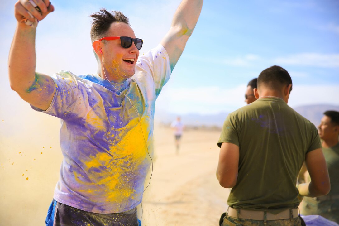 A Marine passes one of the many color stations during Sexual Assault Prevention and Response annual Colorful Consent Run aboard the Marine Corps Air Ground Combat Center, Twentynine Palms, Calif., April 6, 2018. The goal of the 5k color fun run was to have everyone gather to spread awareness while still having fun. (U.S. Marine Corps Photo by Cpl. Christian Lopez)