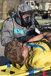 South Carolina National Guard Sgt. Paul Reid and other medics from the 251st Area Support Medical Company, in-process simulated casualties, April 12, 2018, during a drill at Muscatatuck Urban Training Center, Indiana, as part of Exercise Vibrant Response.