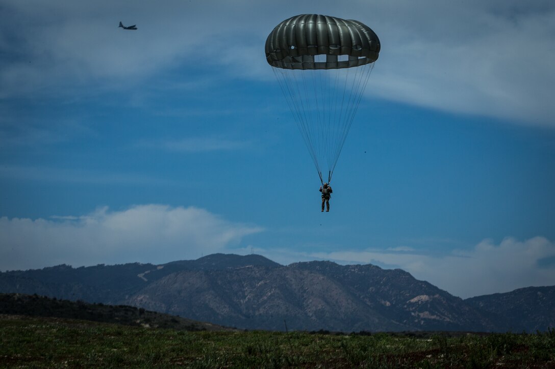 A U.S. Marine with 1st Force Reconnaissance Battalion, 1st Marine Division, descends during Military Free-Fall and Static-Line parachute operations at Marine Corps Base Camp Pendleton, Calif., April 5, 2018. The battalion conducted the operations with Aerial Refueler Transport Squadron 352 to maintain and increase parachuting and jumpmaster proficiency. (U.S. Marine Corps photo by Lance Cpl. Alexa M. Hernandez)