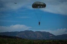 A U.S. Marine with 1st Force Reconnaissance Battalion, 1st Marine Division, descends during Military Free-Fall and Static-Line parachute operations at Marine Corps Base Camp Pendleton, Calif., April 5, 2018.