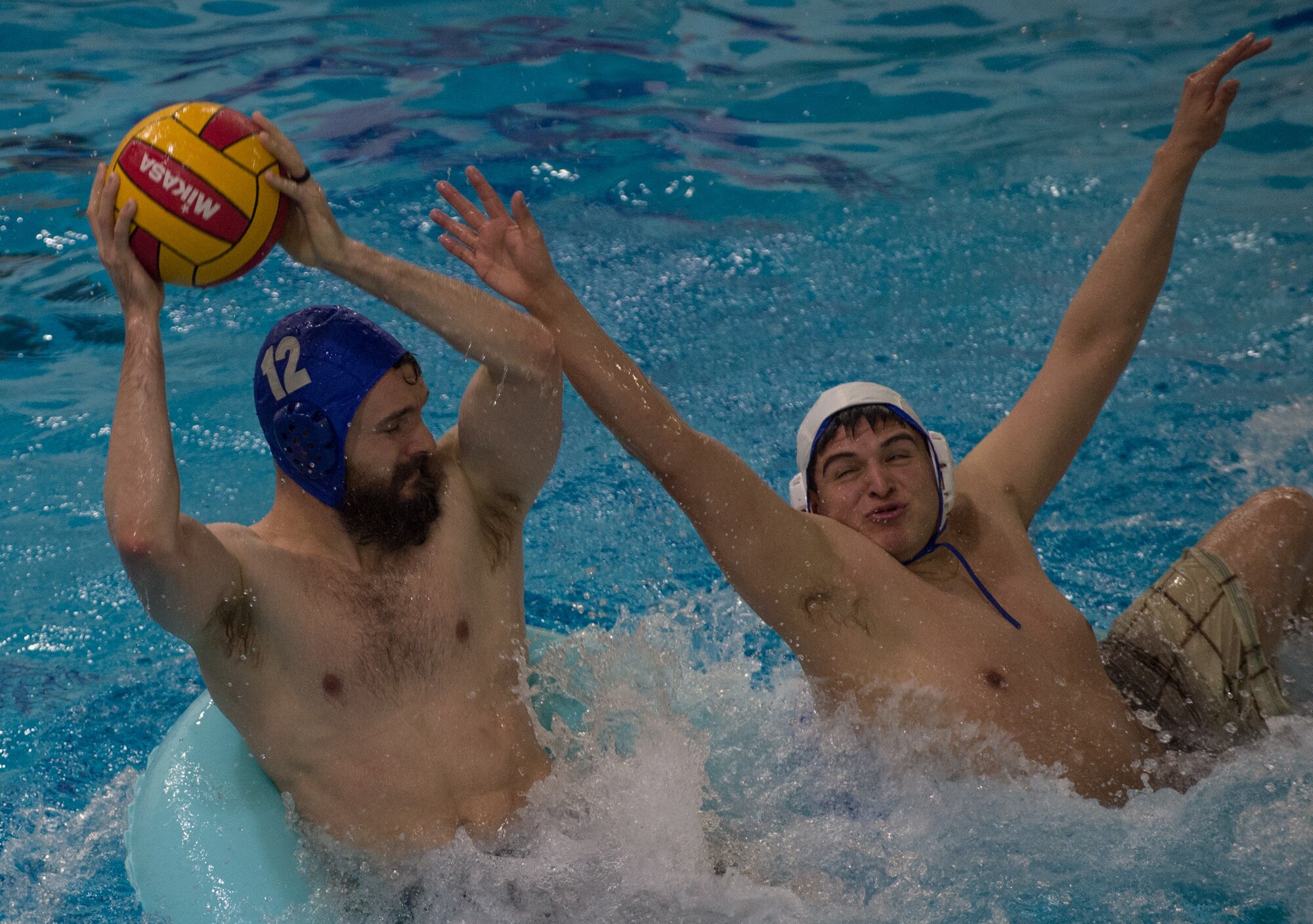 Military members and affiliates participate in an intramural game of water polo on inner tubes at the Buckner Physical Fitness Center on Joint Base Elmendorf-Richardson, Alaska, April 12, 2018. The fitness center offers a total of 18 intramural sports throughout the year, open to military members, family members, Department of Defense civilians and affiliates 18 years and older.