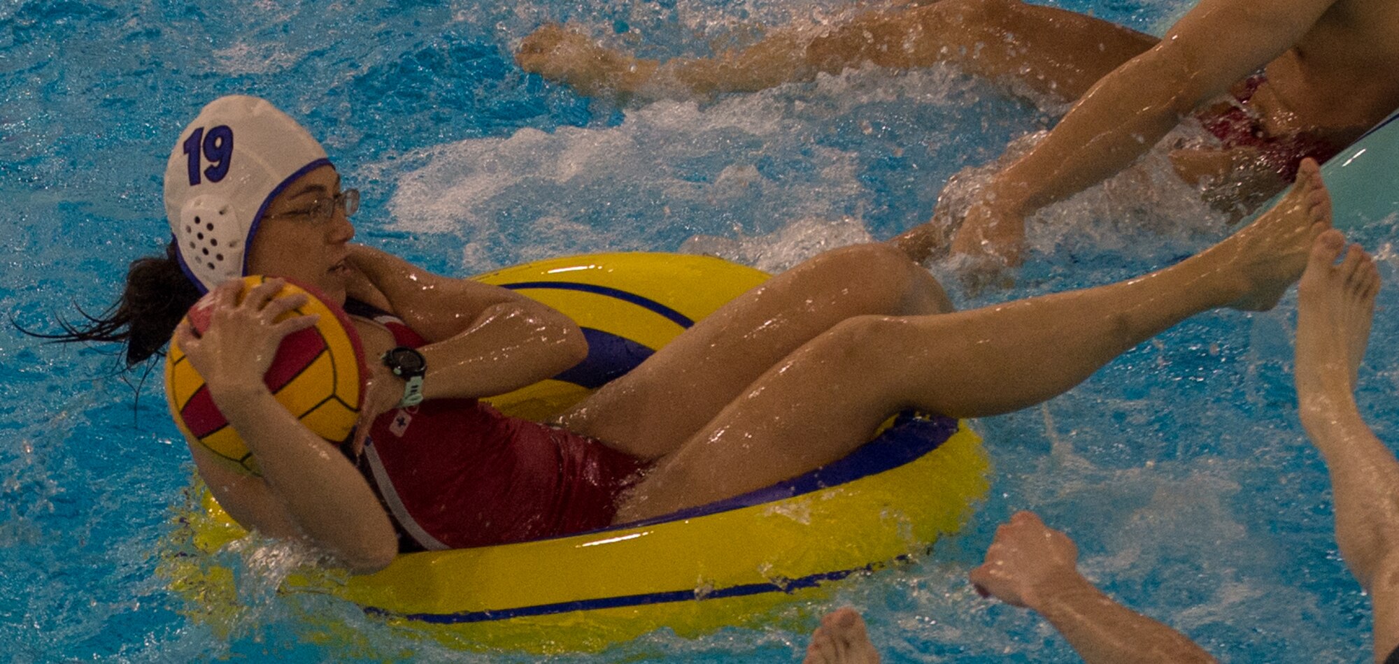 Military members and affiliates participate in an intramural game of water polo on inner tubes at the Buckner Physical Fitness Center on Joint Base Elmendorf-Richardson, Alaska, April 12, 2018. The fitness center offers a total of 18 intramural sports throughout the year, open to military members, family members, Department of Defense civilians and affiliates 18 years and older.