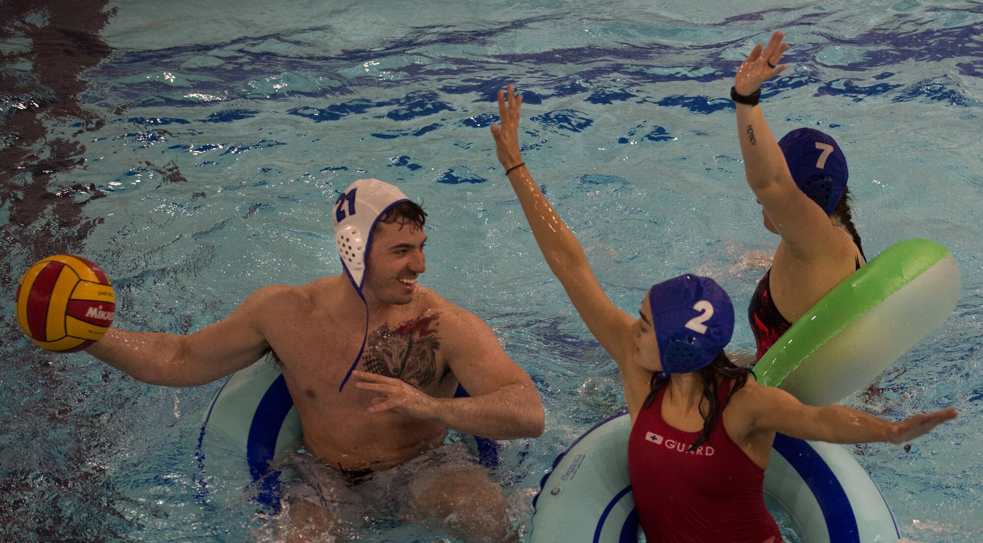 Military members and affiliates participate in an intramural game of water polo on inner tubes at the Buckner Physical Fitness Center on Joint Base Elmendorf-Richardson, Alaska, April 12, 2018. The fitness center offers a total of 18 intramural sports throughout the year, open to military members, family members, Department of Defense civilians and affiliates 18 years and older.