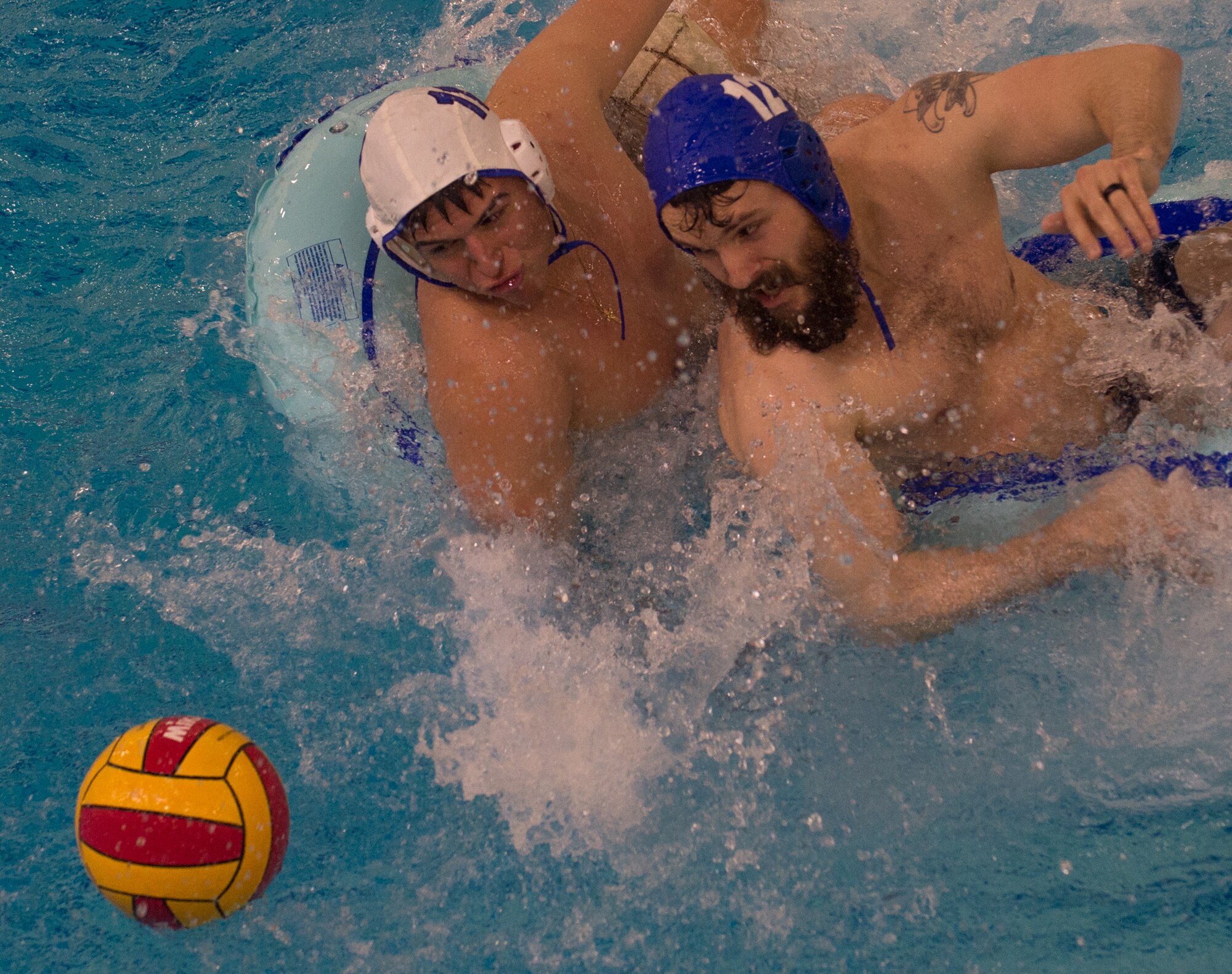 Military members and affiliates participate in an intramural game of water polo on inner tubes at the Buckner Physical Fitness Center on Joint Base Elmendorf-Richardson, Alaska, April 12, 2018. The fitness center offers a total of 18 intramural sports throughout the year, open to military members, family members, Department of Defense civilians and affiliates 18 years and older.
