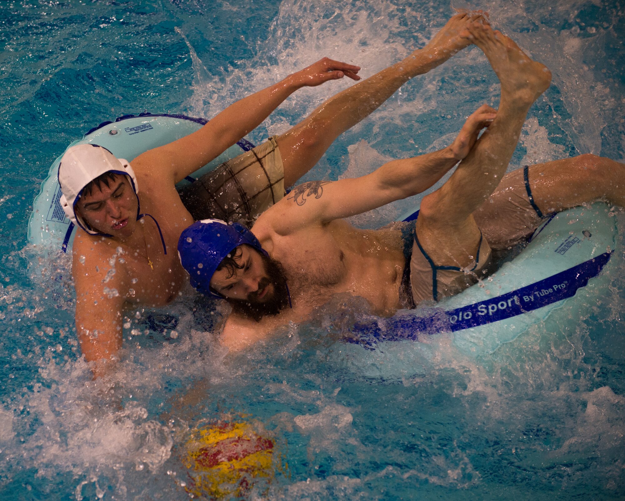 Military members and affiliates participate in an intramural game of water polo on inner tubes at the Buckner Physical Fitness Center on Joint Base Elmendorf-Richardson, Alaska, April 12, 2018. The fitness center offers a total of 18 intramural sports throughout the year, open to military members, family members, Department of Defense civilians and affiliates 18 years and older.