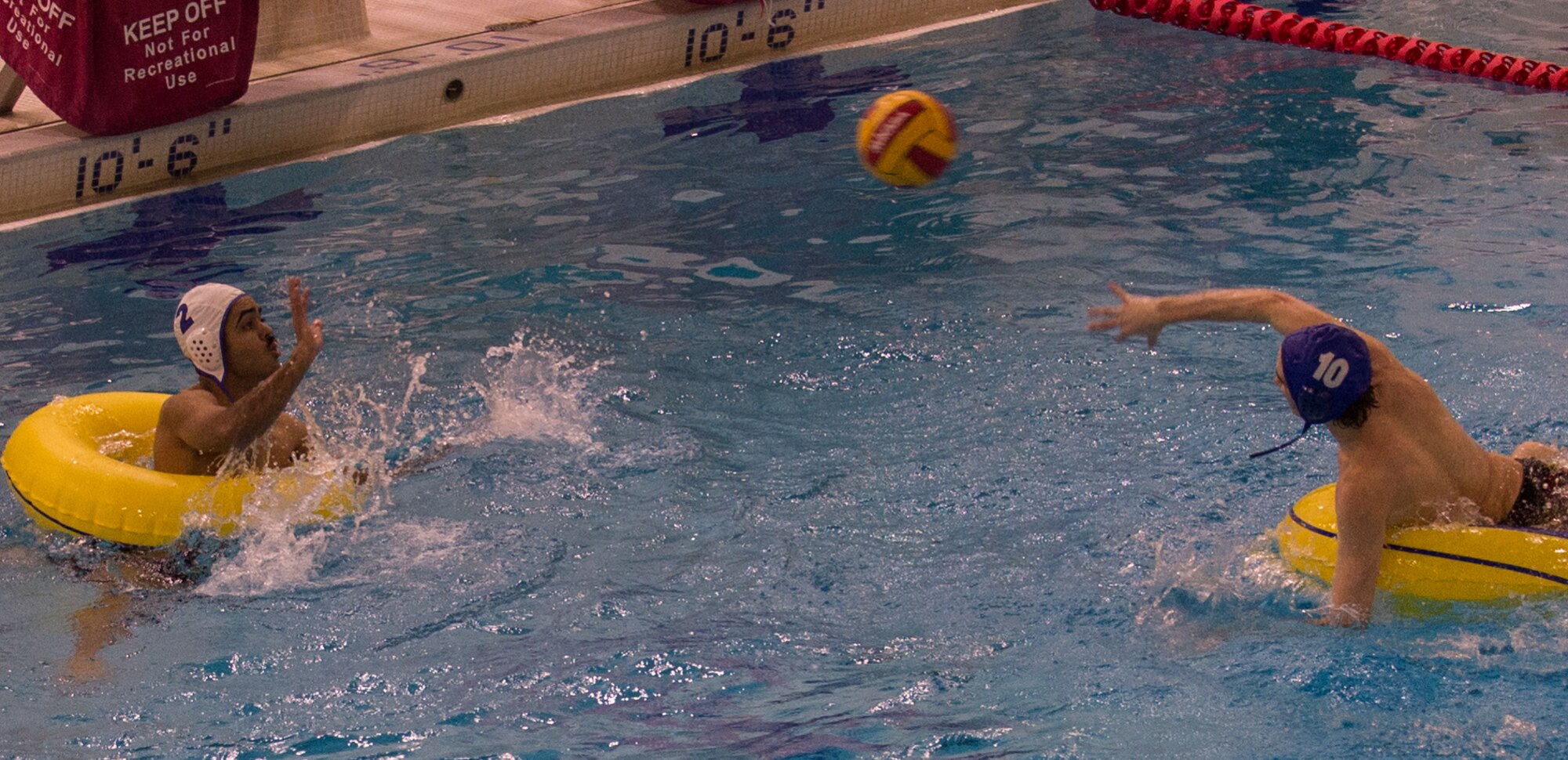 Military members and affiliates participate in an intramural game of water polo on inner tubes at the Buckner Physical Fitness Center on Joint Base Elmendorf-Richardson, Alaska, April 12, 2018. The fitness center offers a total of 18 intramural sports throughout the year, open to military members, family members, Department of Defense civilians and affiliates 18 years and older.