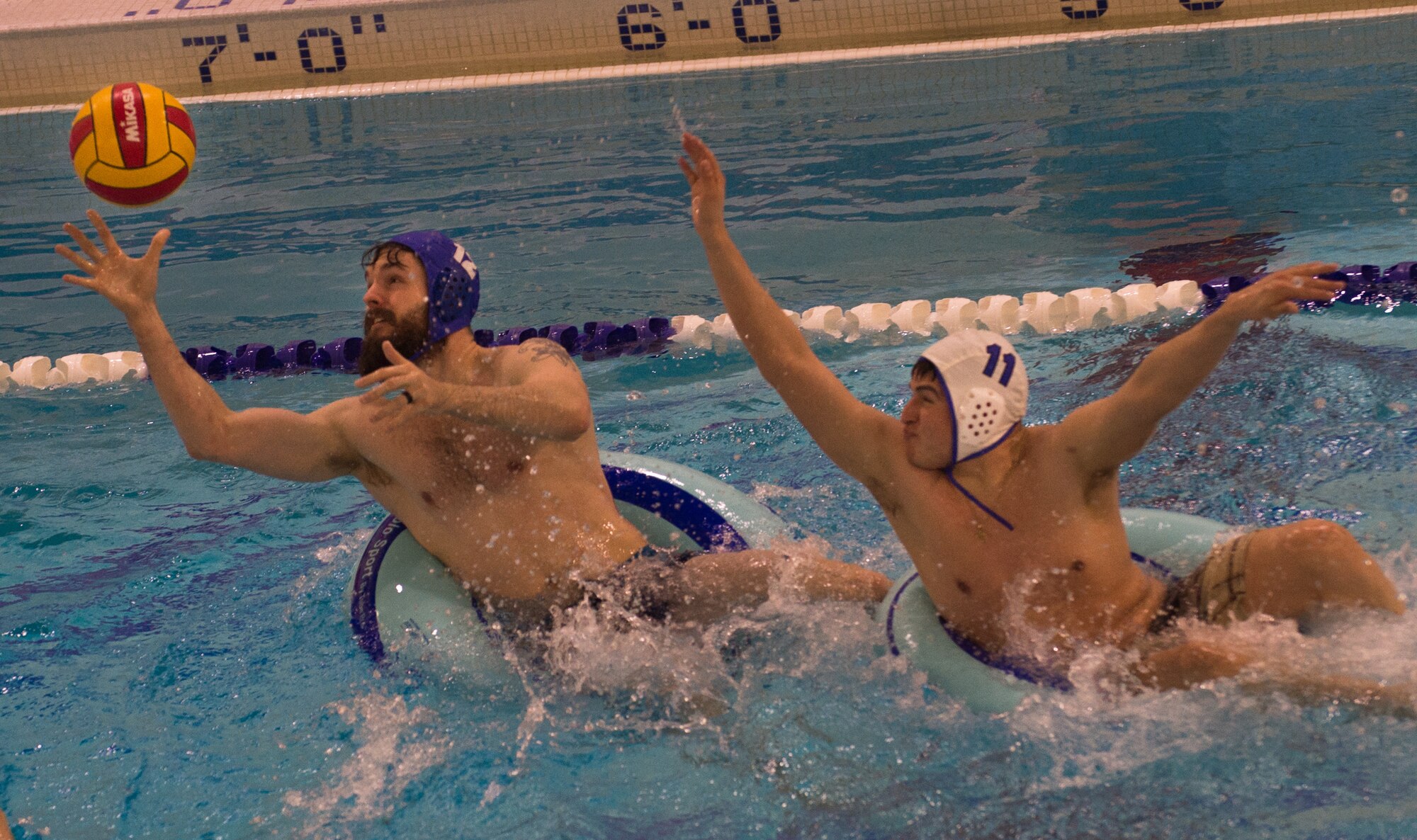 Military members and affiliates participate in an intramural game of water polo on inner tubes at the Buckner Physical Fitness Center on Joint Base Elmendorf-Richardson, Alaska, April 12, 2018. The fitness center offers a total of 18 intramural sports throughout the year, open to military members, family members, Department of Defense civilians and affiliates 18 years and older.